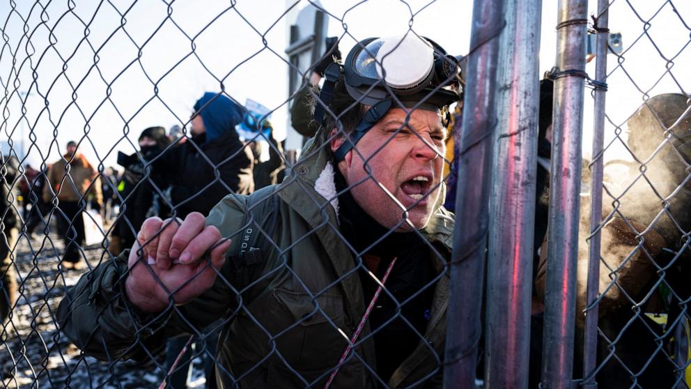 PHOTO: A protester shouts at officers of the Sheriff's office that were clearing demonstrators from the main road leading to the Bishop Henry Whipple Federal Building in Minneapolis, Minnesota, January 30, 2026. 