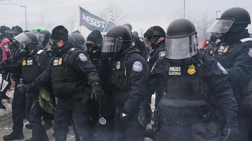 PHOTO: Federal immigration officers confront protesters outside Bishop Henry Whipple Federal Building, Jan. 15, 2026, in Minneapolis.