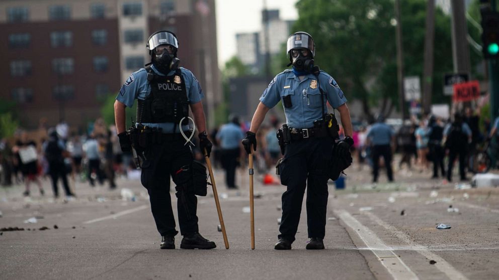 PHOTO: Police officers stand outside the Third Police Precinct during a protest on May 27, 2020, in Minneapolis.