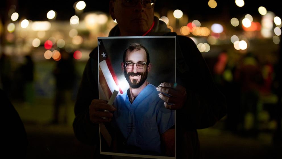 PHOTO: A person holds a picture during a vigil for Alex Pretti, who was shot and killed by federal immigration enforcement in Minneapolis, Jan. 28, 2026, in Henderson, Nev.