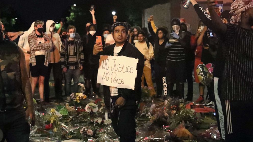 PHOTO: Demonstrators gather at the site of George Floyd's death while under arrest by police officers in Minneapolis, May 31, 2020.