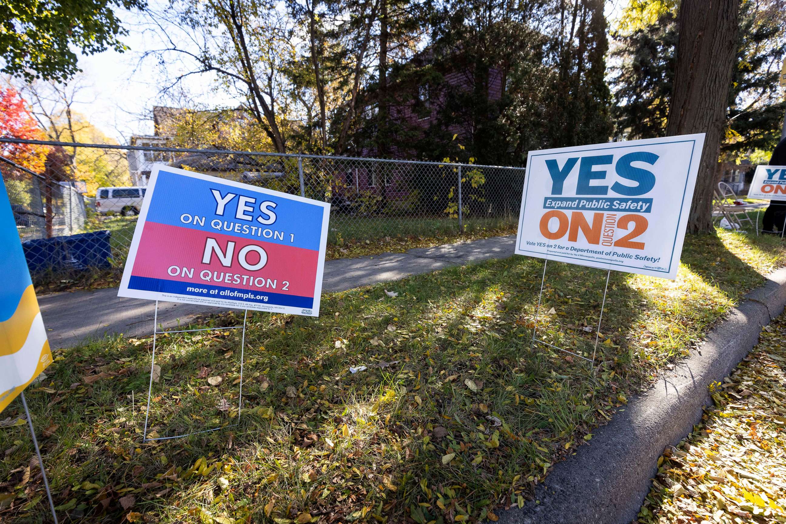 PHOTO: Lawn signs in favor of opposite positions are placed outside of a polling place on Nov. 2, 2021, in Minneapolis.