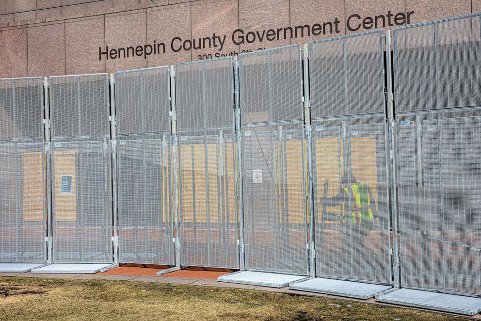 PHOTO: A worker installs security fencing at the Hennepin County Government Headquarters in Minneapolis, March 3, 2021, before jury selection begins at the trial of former Minneapolis Police officer Derek Chauvin in George Floyd's death on March 8.