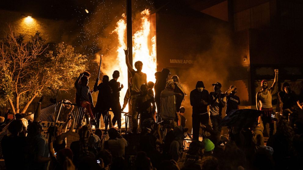 PHOTO: Protesters cheer as the Minneapolis Police Department's Third Precinct burns behind them in Minneapolis, Minnesota, on May 28, 2020.