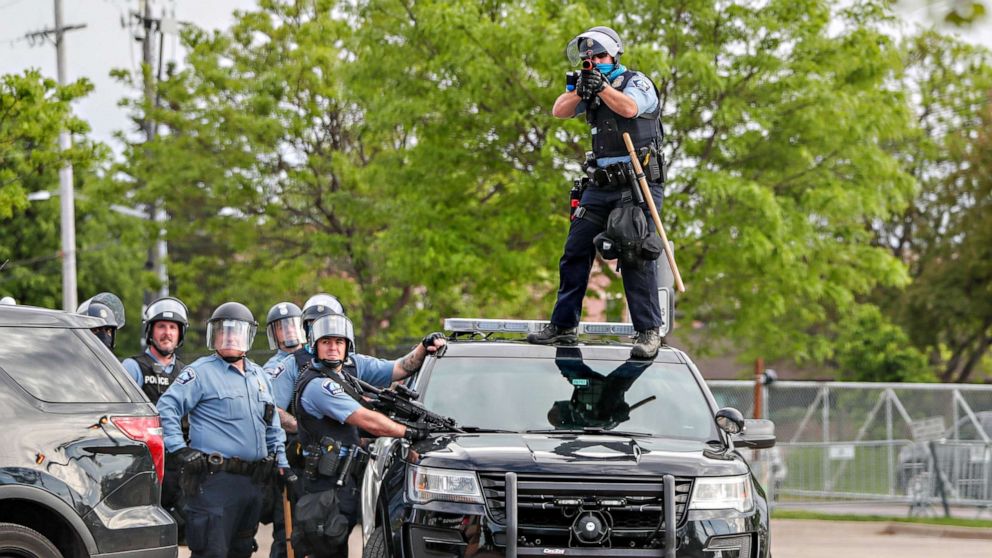PHOTO: A police officer aims before firing at protestors gathered near the Minneapolis Police third precinct after the death of an African-American man, George Floyd, in Minneapolis, May 27, 2020.