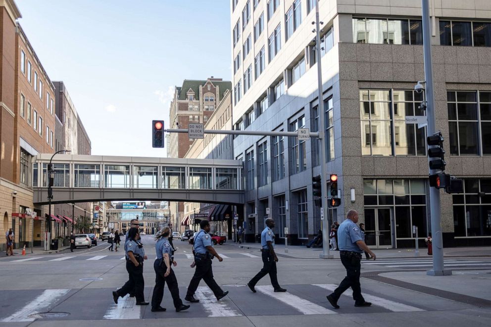 PHOTO: A group of police officers walks along an empty street in downtown Minneapolis, Sept. 8, 2021.