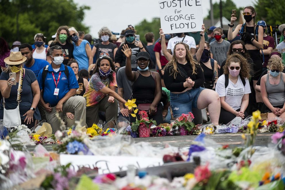 PHOTO: People gather on June 1, 2020, in Minneapolis, at site where George Floyd died May 25 while in police custody.