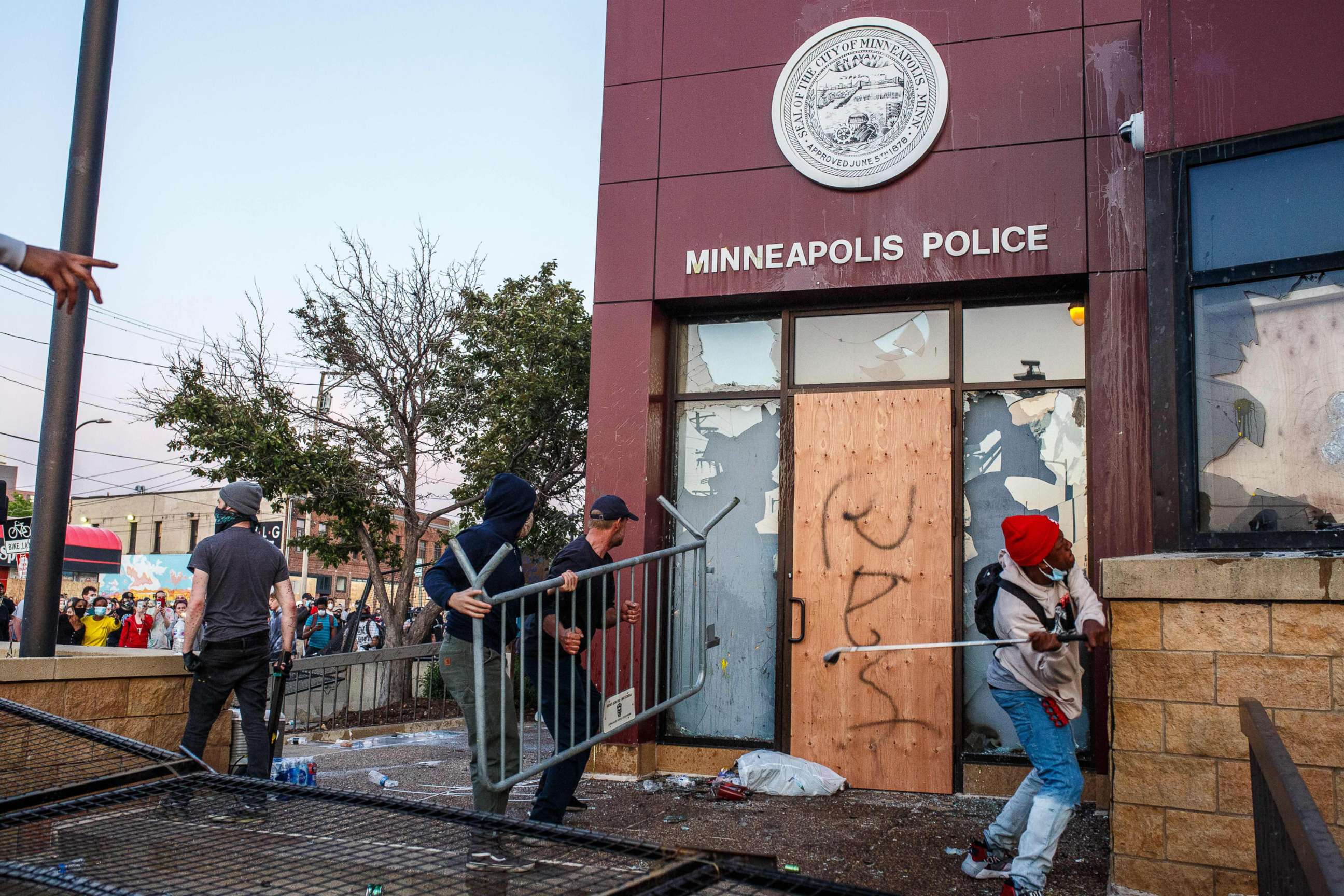 PHOTO: In this May 28, 2020, file photo, protesters use a barricade to try and break the windows of the Third Police Precinct in Minneapolis during a protest over the death of George Floyd.