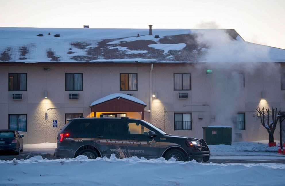 PHOTO: A sheriff's vehicle sits outside the Super 8 Motel where alleged suspect Gregory Ulrich apparently stayed the night before a shooting at the nearby Allina Health Clinic on Feb. 9, 2021 in Buffalo, Minn. 