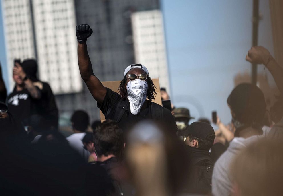 PHOTO: A crowd marches to protest the death of George Floyd on the Hennepin Avenue Bridge over the Mississippi River, May 31, 2020, in Minneapolis, Minnesota.