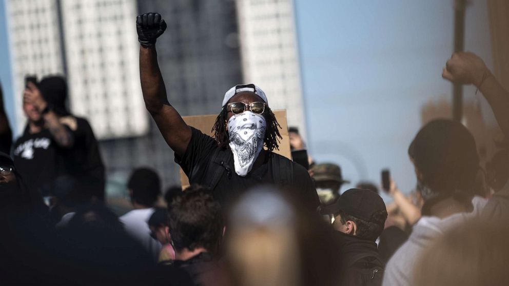 PHOTO: A crowd marches to protest the death of George Floyd on the Hennepin Avenue Bridge over the Mississippi River, May 31, 2020, in Minneapolis, Minnesota.