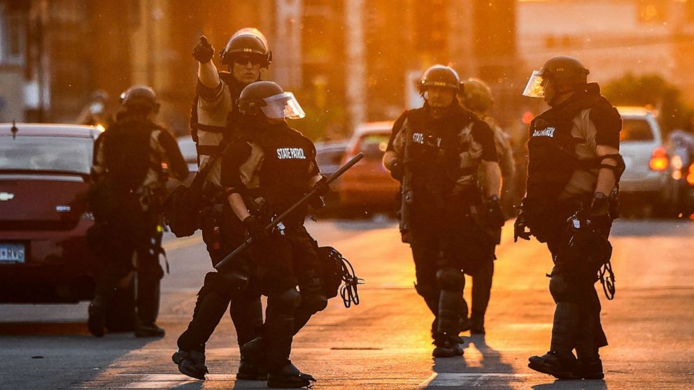 PHOTO: Police officers take guard during a protest over the death of George Floyd, May 31, 2020, in Minneapolis, Minnesota. 