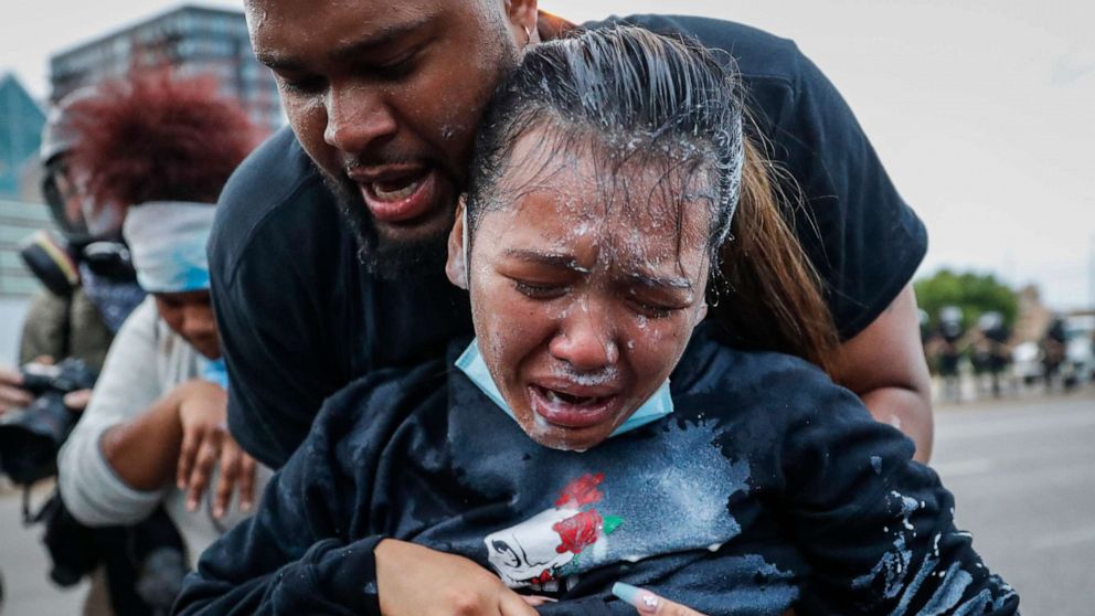 PHOTO: A protester reacts after being hit by pepper spray from police as their group of demonstrators are detained prior to arrest at a gas station on South Washington Street, May 31, 2020, in Minneapolis.