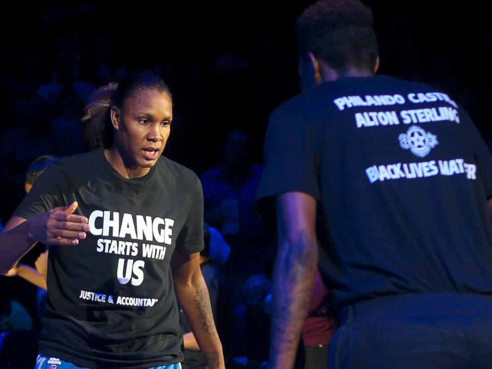 PHOTO: Minnesota Lynx forward Rebekkah Brunson (32) is greeted by Minnesota Lynx forward Natasha Howard (3) while starting lineups are announced at the Target Center, July 9, 2016.