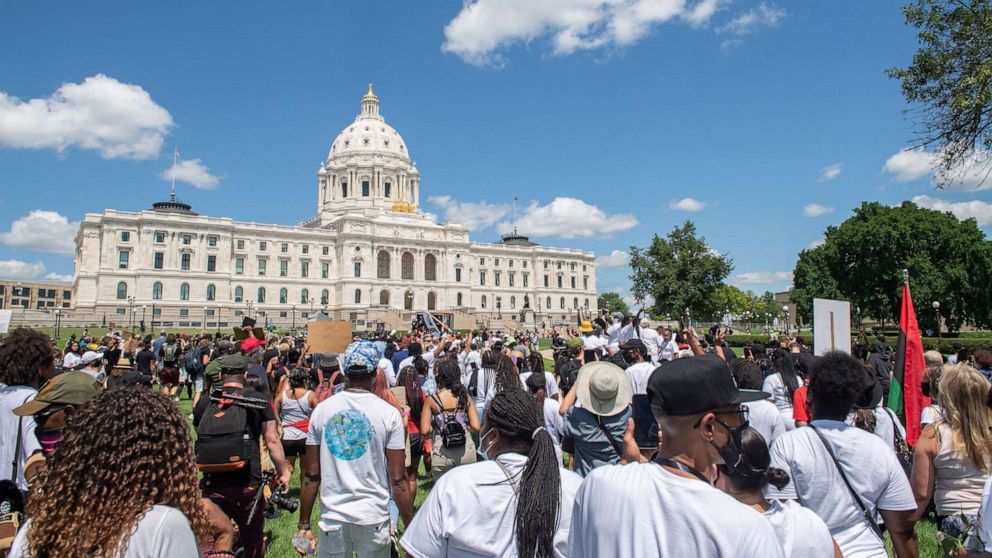 PHOTO: Marchers walk on the lawn of the State Capitol during a National Mother's March in St. Paul, Minn., July 12, 2020.