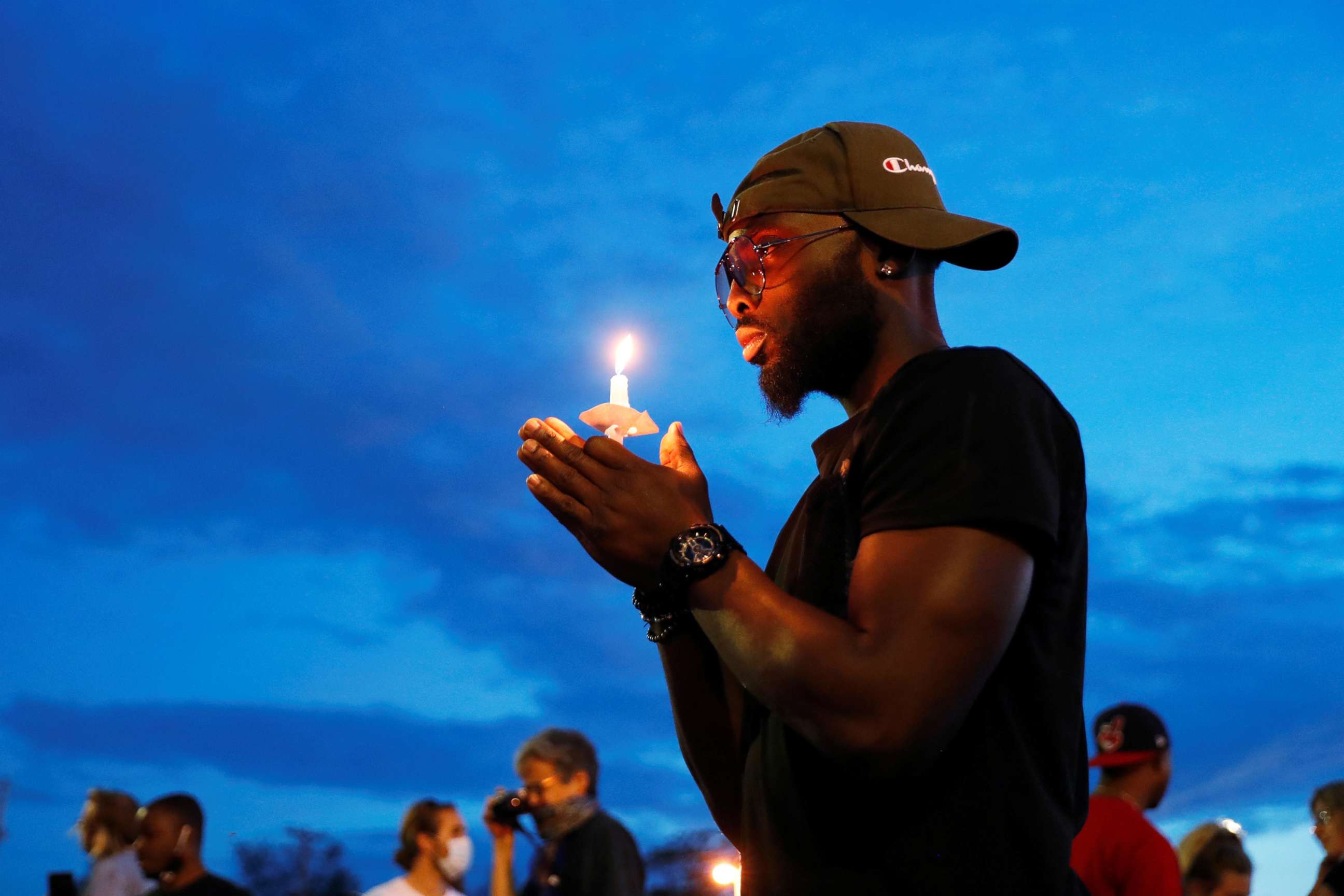 PHOTO: A man holds a candle at the scene of the death, in police custody, of George Floyd, in Minneapolis, June 3, 2020.