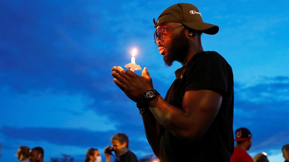 PHOTO: A man holds a candle at the scene of the death, in police custody, of George Floyd, in Minneapolis, June 3, 2020.