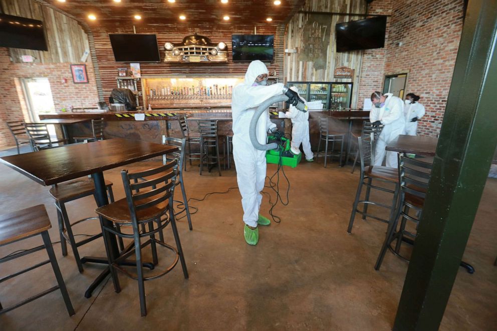 PHOTO: Workers from Servpro disinfect Mugshots restaurant in Tupelo, Miss., Friday, July 17, 2020, as the restaurant is preparing to open for business.