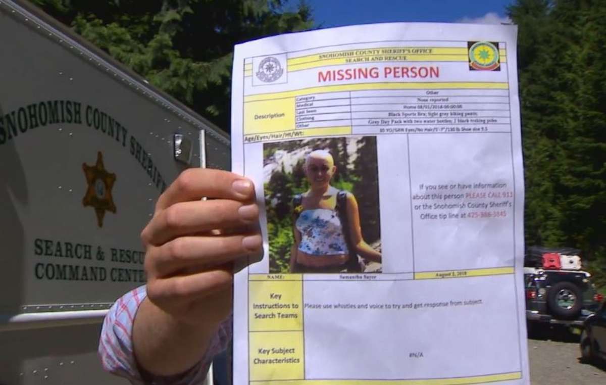 Snohomish County authorities hold a missing person poster for Sam Sayers, 28, who never returned from a hike on Vesper Peak in Washington on Wednesday, Aug. 1, 2018.