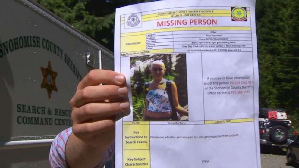 Snohomish County authorities hold a missing person poster for Sam Sayers, 28, who never returned from a hike on Vesper Peak in Washington on Wednesday, Aug. 1, 2018.