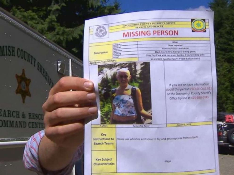 Snohomish County authorities hold a missing person poster for Sam Sayers, 28, who never returned from a hike on Vesper Peak in Washington on Wednesday, Aug. 1, 2018.