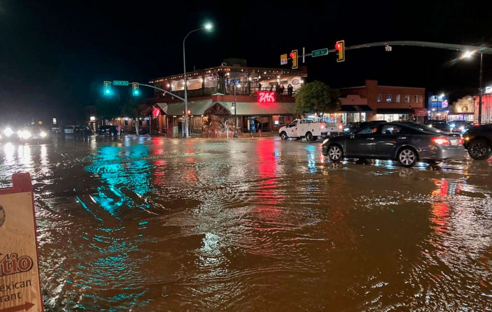 PHOTO: Vehicles navigate high waters at the intersection of South Main Street and 100 South in Moab, Utah, Aug. 20, 2022.