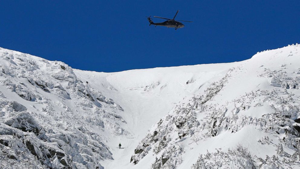 A National Guard helicopter flies over Mount Washington while searching for missing hiker, 70-year-old Christophe Chamley of Massachusetts, April 23, 2018. New Hampshire Fish and Game officials are calling a search a waste of time, money and resources after he was found at a luxury hotel.