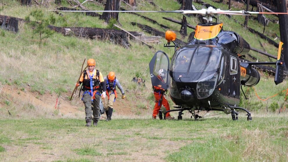 PHOTO: Jackson County Searchers exit a Brim Aviation helicopter after finding Harry Burleigh, in a photo released by the Douglas Co. Sheriff's Office in Oregon, May 23, 2021.