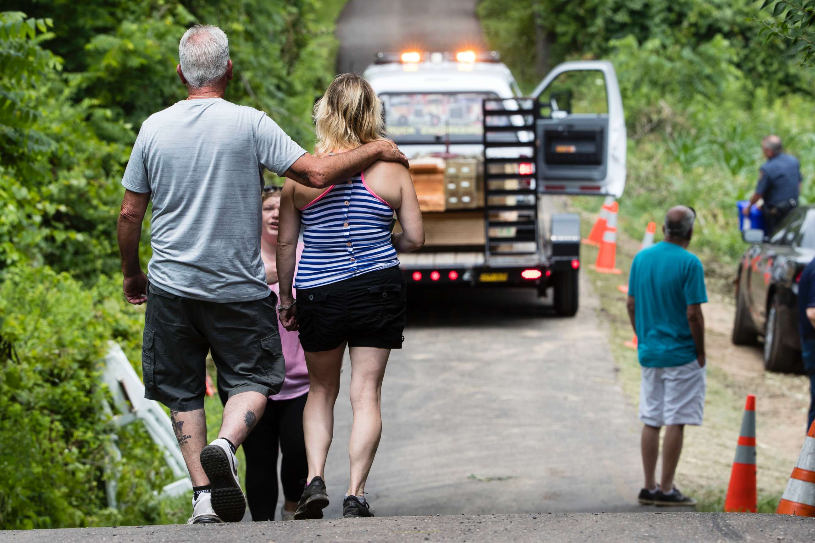PHOTO: People walk at the entrance to a blocked off drive way, in Solebury, Pa., as the search continues Wednesday, July 12, 2017, for four missing young Pennsylvania men feared to be the victims of foul play.