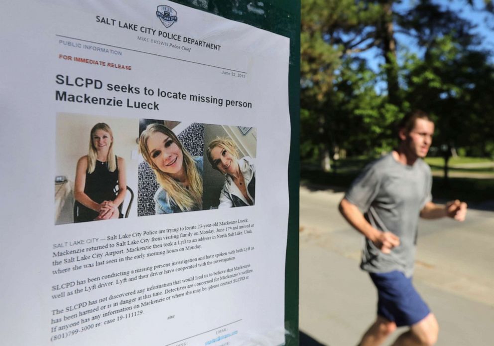 PHOTO: A jogger runs pass a poster of Mackenzie Lueck at Liberty Park in Salt Lake City, June 24, 2019.