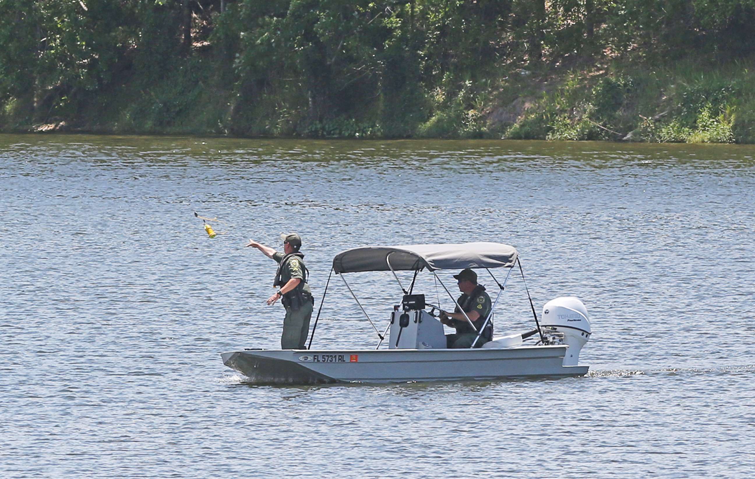 PHOTO: Sheriff's deputies conduct a search a east Orange County lake, May 9, 2018, in Florida after a report of a teenager struggling in the water. 