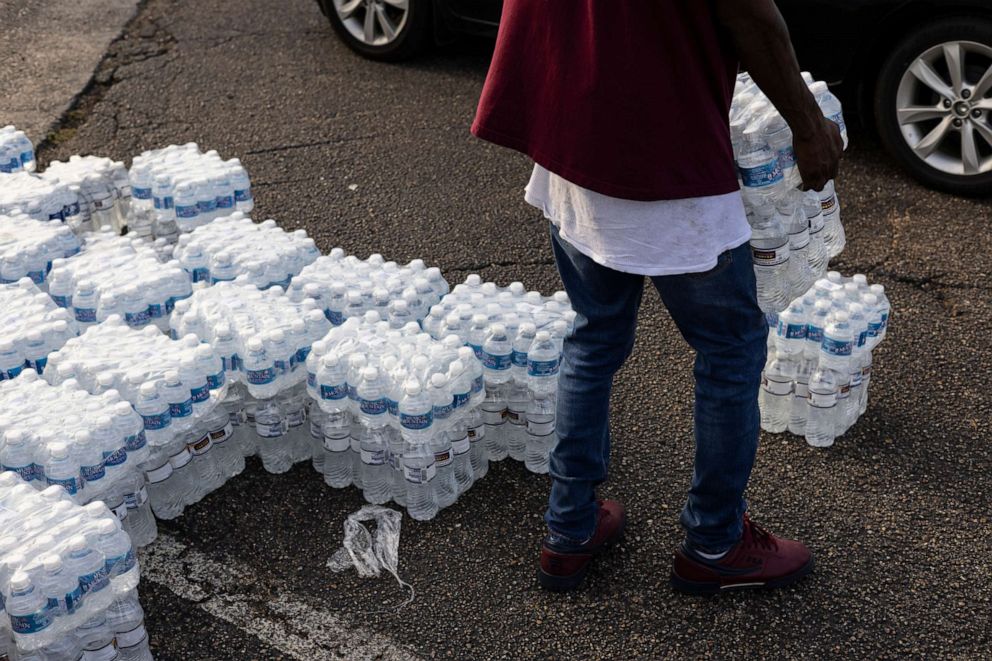 PHOTO: Cases of bottled water are handed out at a Mississippi Rapid Response Coalition distribution site, Aug. 31, 2022, in Jackson, Miss.