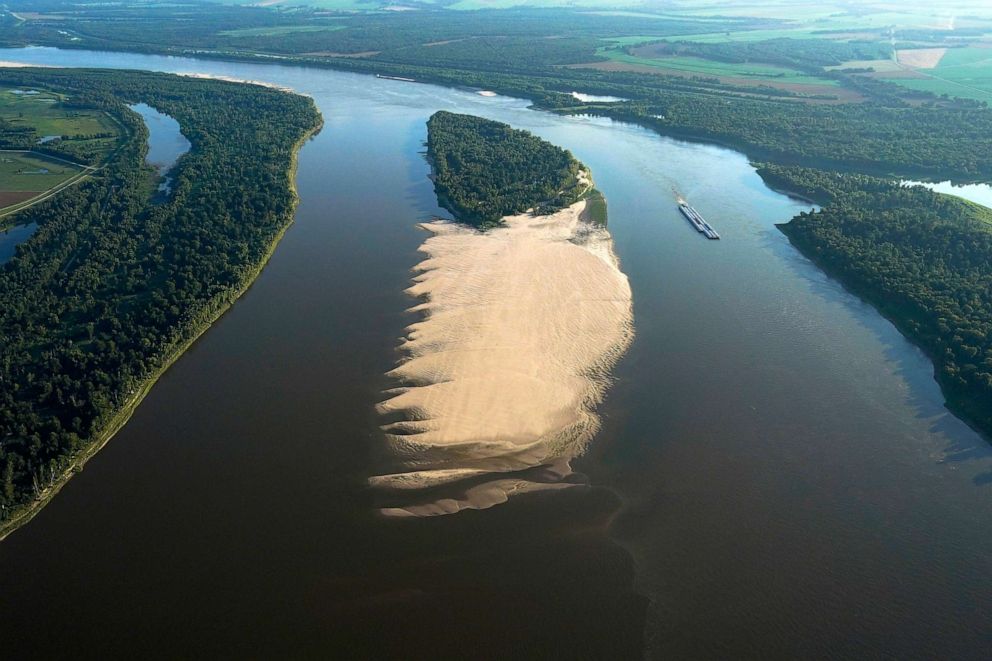 PHOTO: In this July 21, 2023, file photo, a tugboat with barges navigates around a sandbar during a period of low water level in the Mississippi River, in West Feliciana Parish, La.