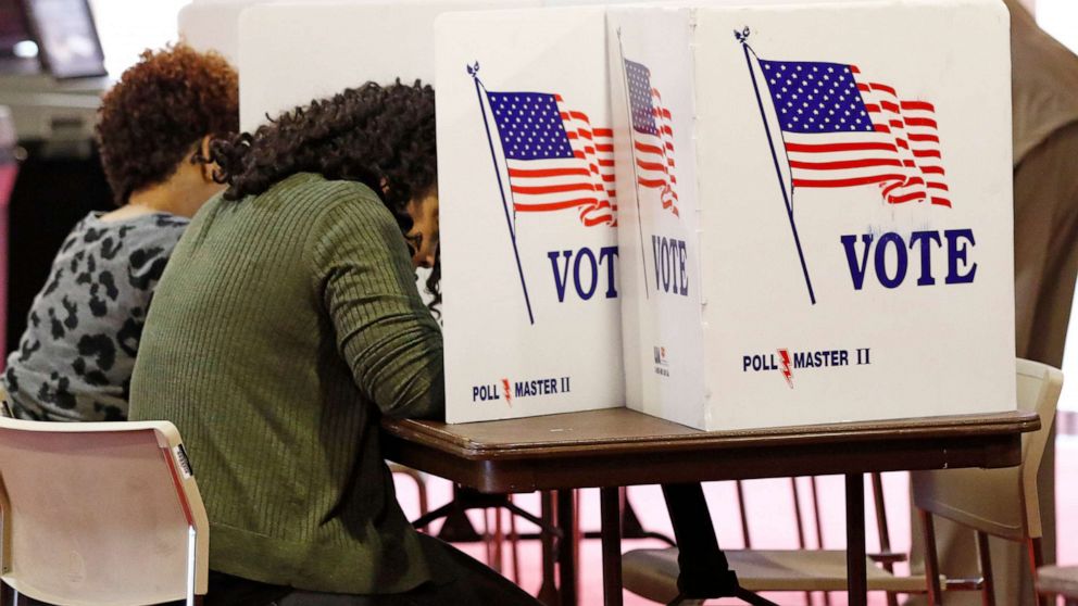PHOTO: In this March 10, 2020, file photo, voters work on their ballots in the kiosks in Jackson, Miss.