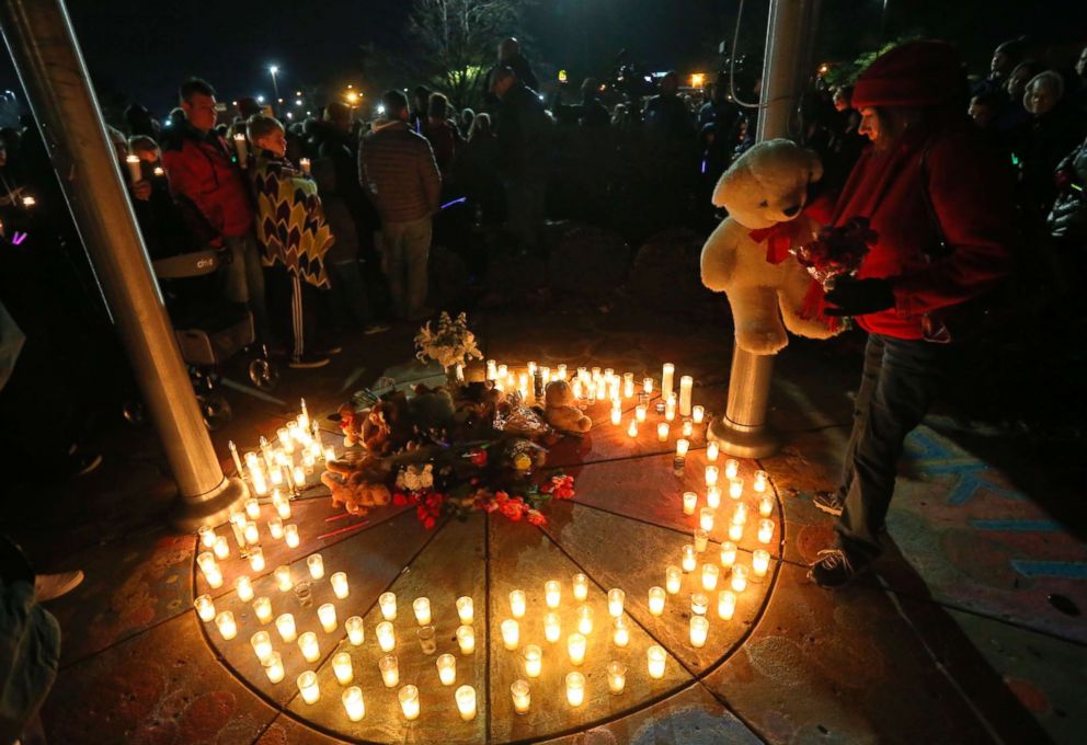 PHOTO: Barb Moran places a stuffed animal in the center of a memorial in honor of Kate Kasten and her children in St. Charles, Mo., Dec. 30, 2018. 