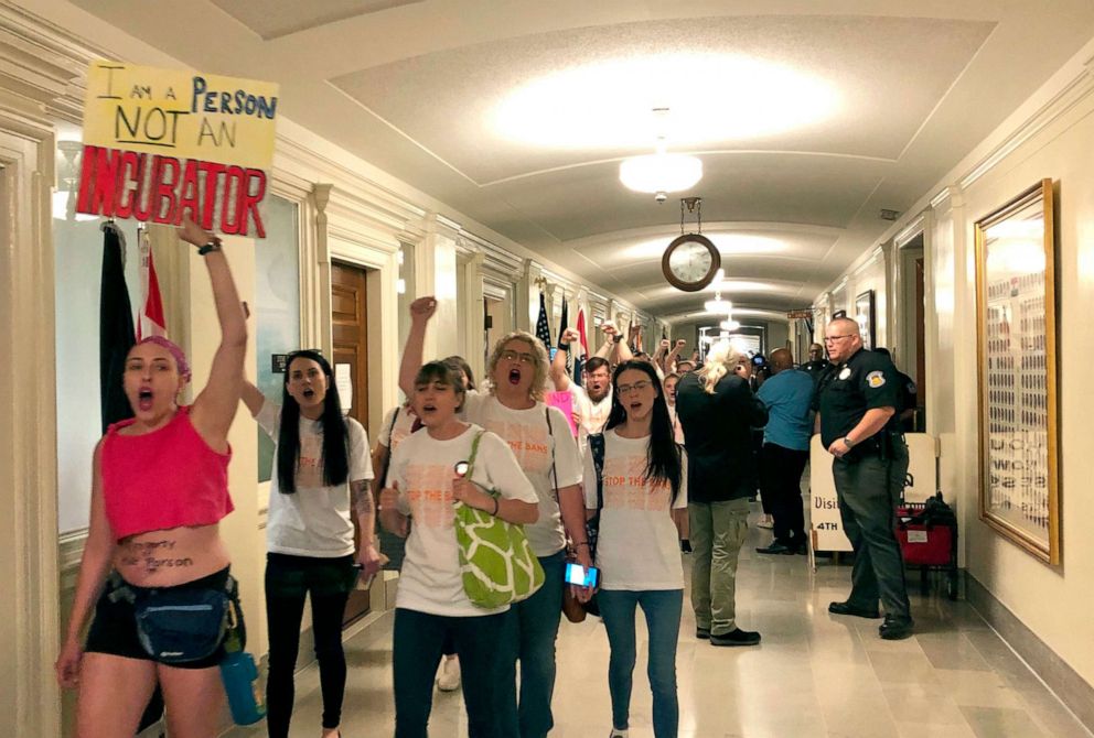 PHOTO: Protesters march through the halls of the Missouri Capitol outside the House chamber, May 17, 2019, in Jefferson City, Missouri, in opposition to legislation prohibiting abortions at eight weeks of pregnancy.