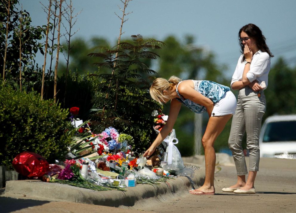 PHOTO: People look at a memorial in front of Ride the Ducks, July 21, 2018 in Branson, Mo.