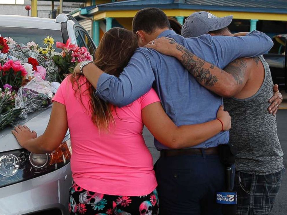 PHOTO: People pray by a car thought to belong to a victim of Thursday's boating accident before a candlelight vigil in the parking lot of Ride the Ducks, July 20, 2018, in Branson, Mo.