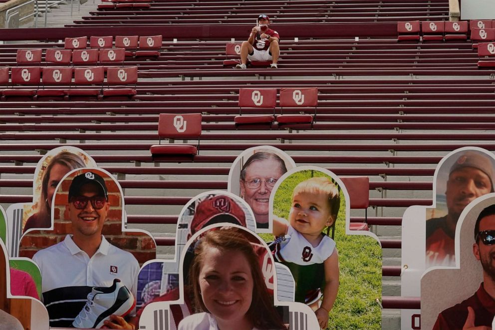 PHOTO: An early arriving fan waits for the Missouri State Bears vs. Oklahoma Sooners NCAA college football game to start, socially distanced from other seating areas, in Norman, Oklahoma, on Sept. 12, 2020.