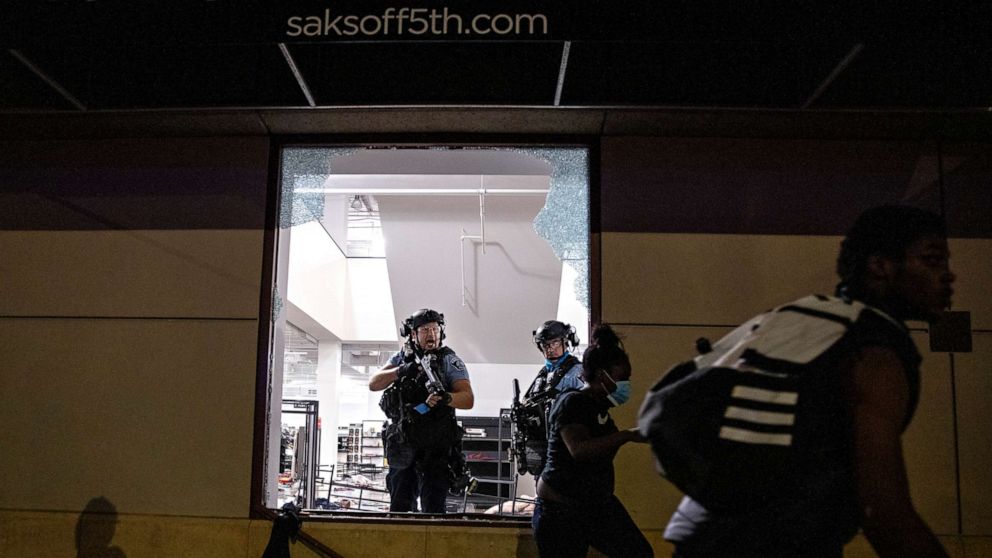 PHOTO: Police clear out and secure Saks OFF 5th after people broke in on Aug. 26, 2020, in Minneapolis.