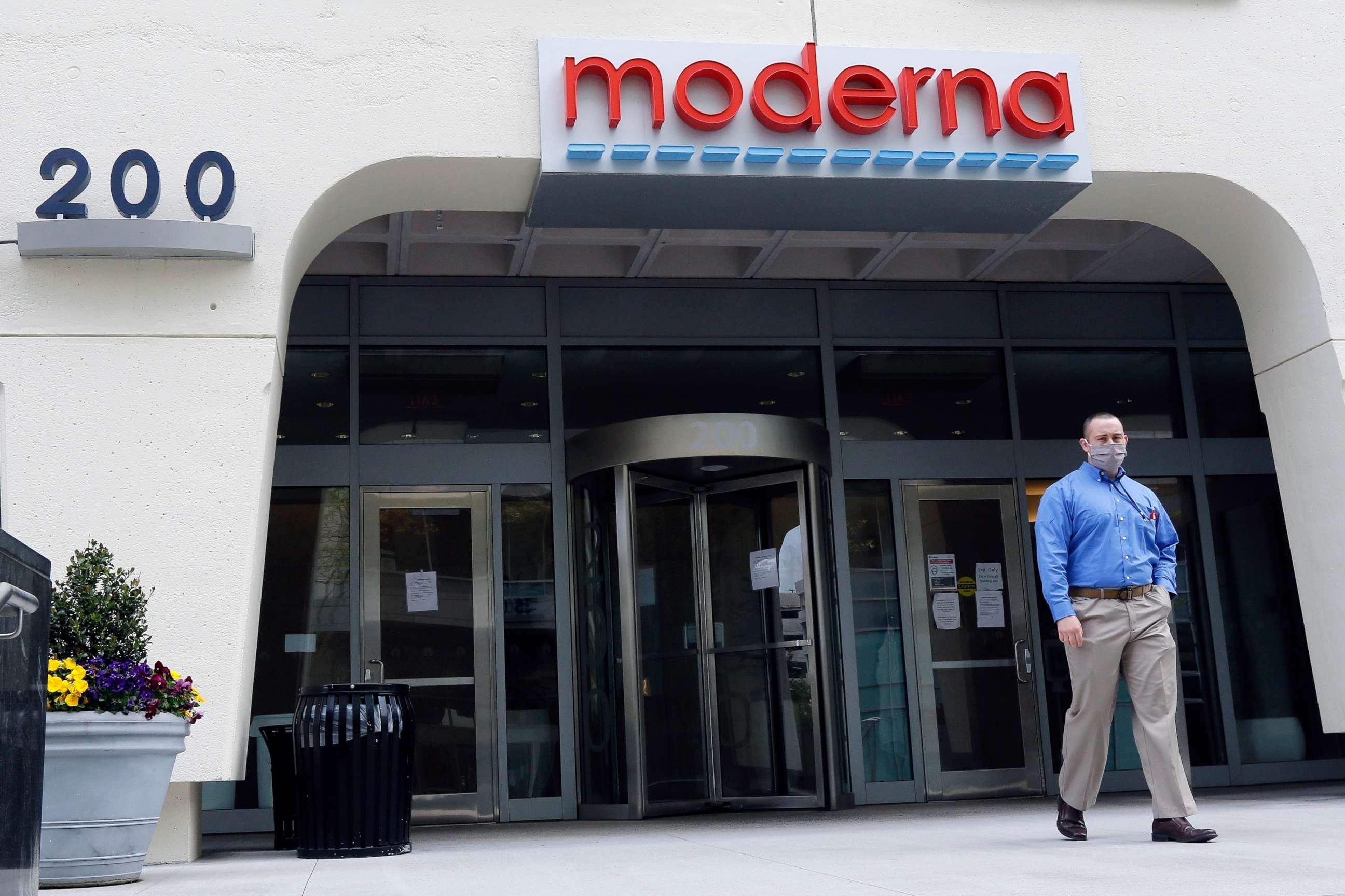 PHOTO: A man stands outside an entrance to a Moderna, Inc., building, Monday, May 18, 2020, in Cambridge, Mass.