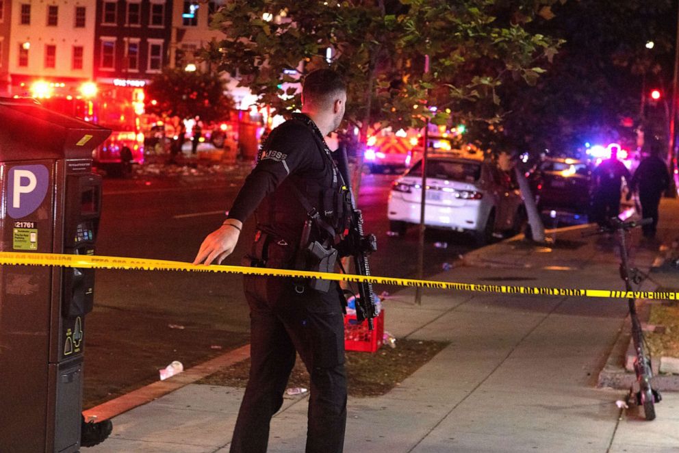 PHOTO: A U.S. Secret Service officer responds after 4 people were shot at the end of the Moechella concert at 14th and U Streets in Washington, D.C., on June 19, 2022.
