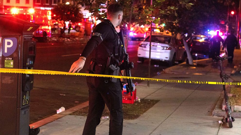 PHOTO: A U.S. Secret Service officer responds after 4 people were shot at the end of the Moechella concert at 14th and U Streets in Washington, D.C., on June 19, 2022.