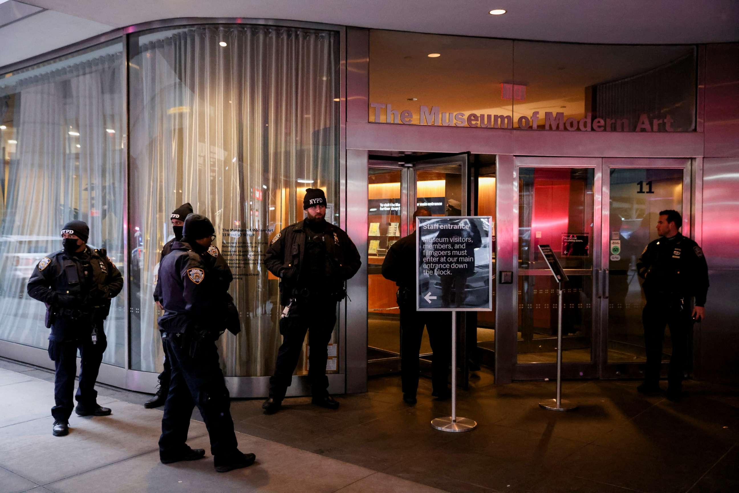 PHOTO: Members of the New York City Police Department gather at the entrance of the Museum of Modern Art after an alleged multiple stabbing incident, in New York, March 12, 2022. 