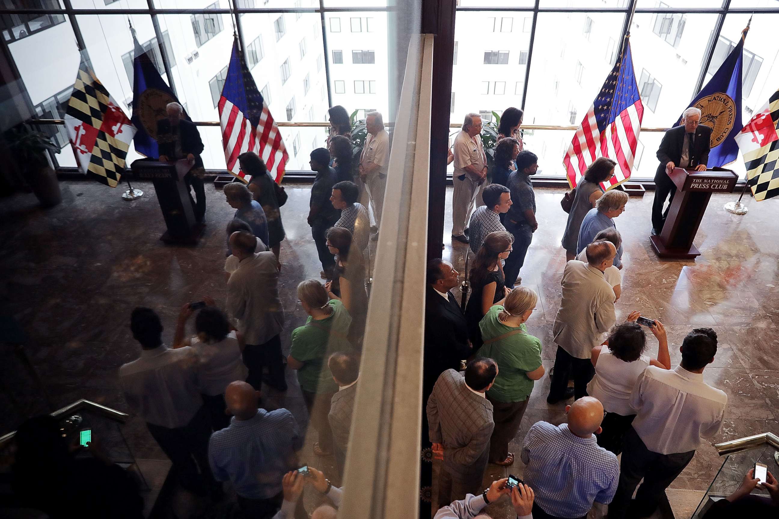 PHOTO: Members and guests of the National Press Club observe a moment of silence to honor the victims of last week's shooting at the Annapolis Capital Gazette newspaper July 5, 2018 in Washington, DC.