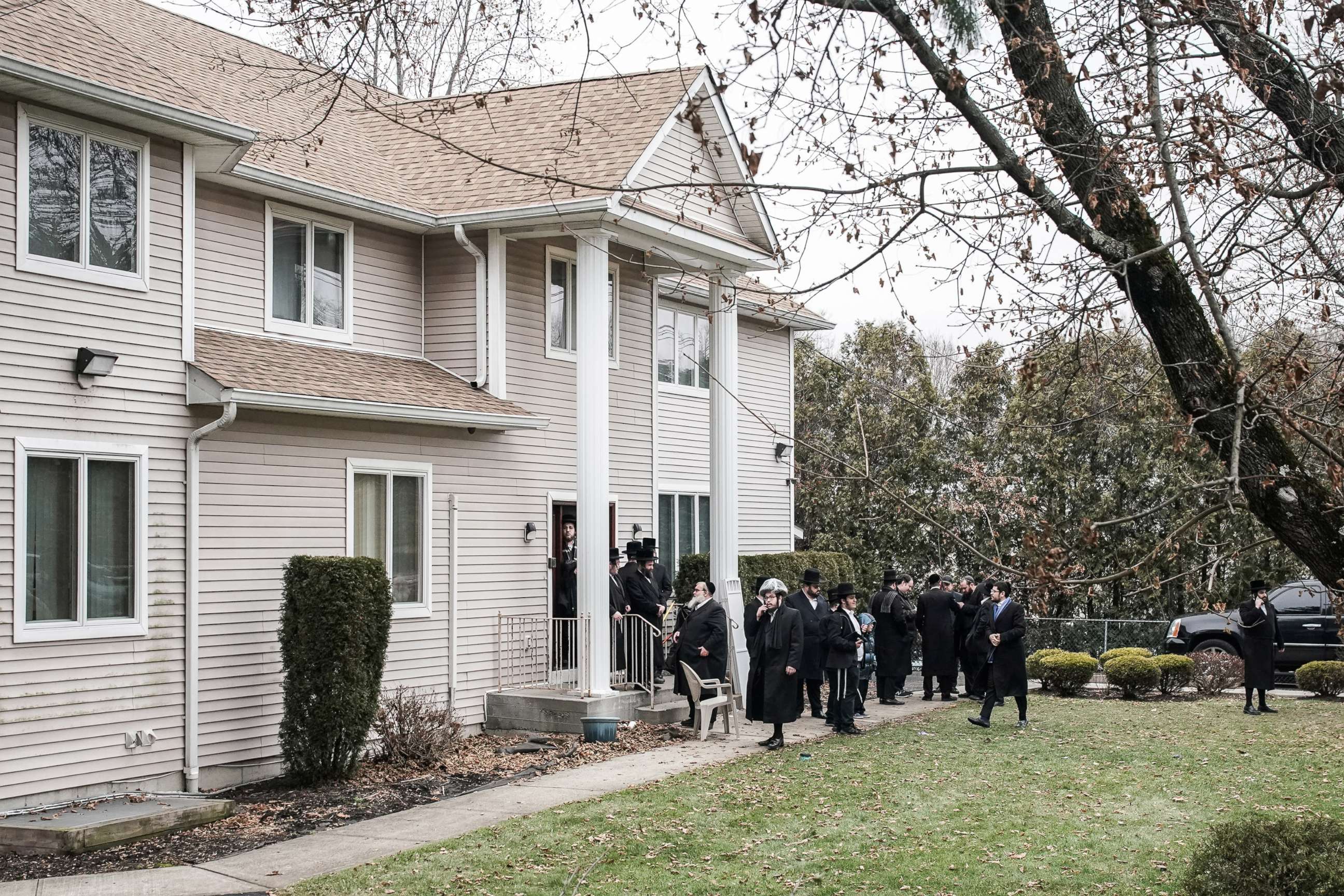 PHOTO: People gather at Rabbi Chaim Rottenberg's residence in Monsey, N.Y., Dec. 29, 2019.