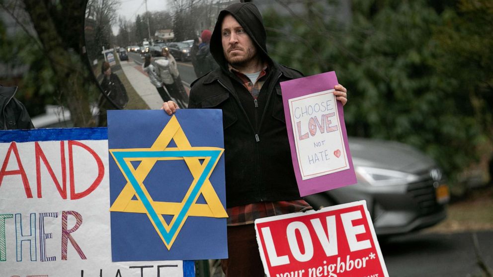 PHOTO: A man holds a sign outside the home of rabbi Chaim Rottenberg in Monsey, New York, Dec. 29, 2019.