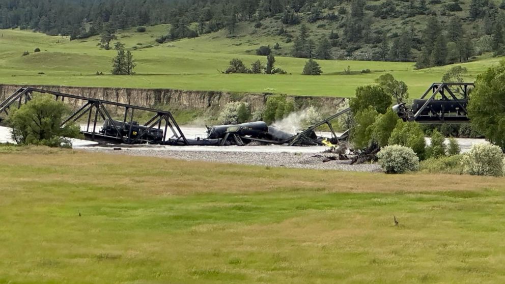 PHOTO: Several train cars are immersed in the Yellowstone River after a bridge collapse near Columbus, Mont., on June 24, 2023.