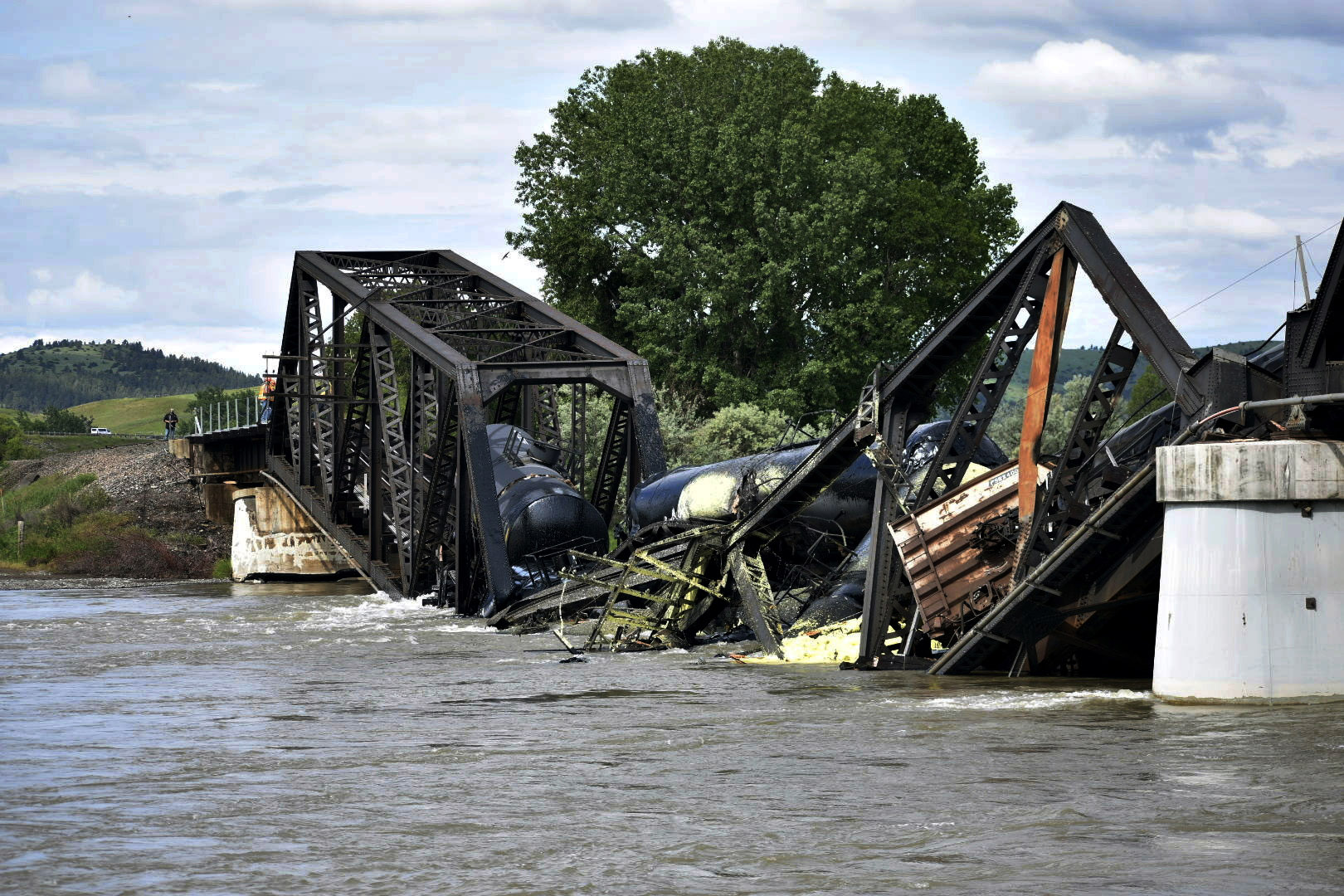 PHOTO: Several train cars are immersed in the Yellowstone River after a bridge collapse near Columbus, Montana, on June 24, 2023.