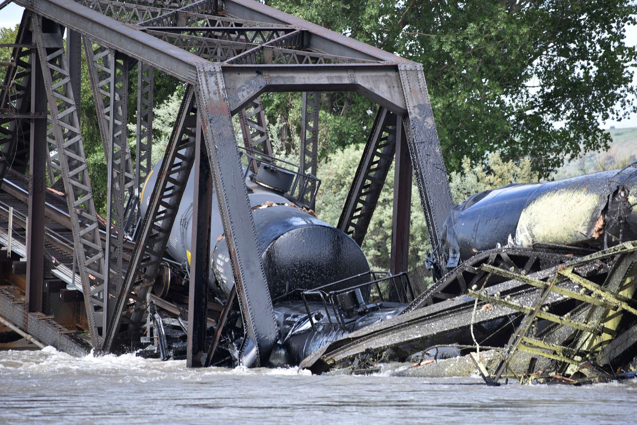 PHOTO: Several train cars are immersed in the Yellowstone River after a bridge collapse near Columbus, Mont., on June 24, 2023.